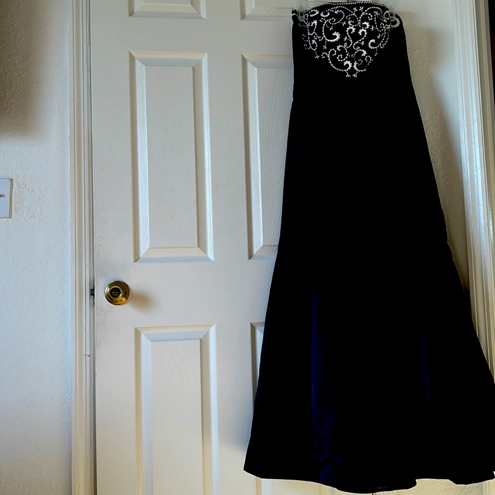 Long black dress with top accented with baroque embroidery.